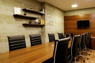 Elegant boardroom with leather chairs and wooden decor, ideal for meetings.